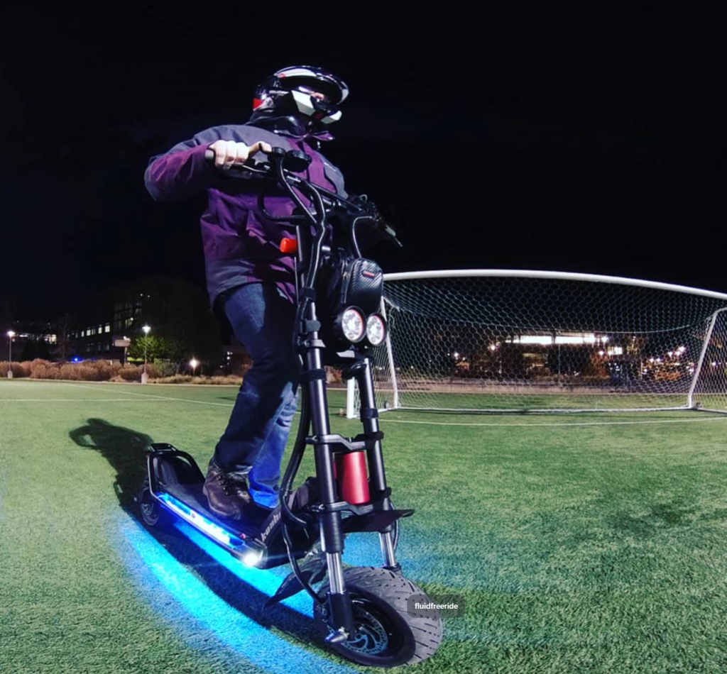 ginger on wheels standing on his first scooter